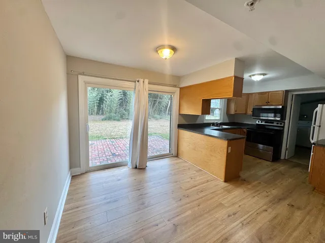 a large kitchen with a sink and stainless steel appliances