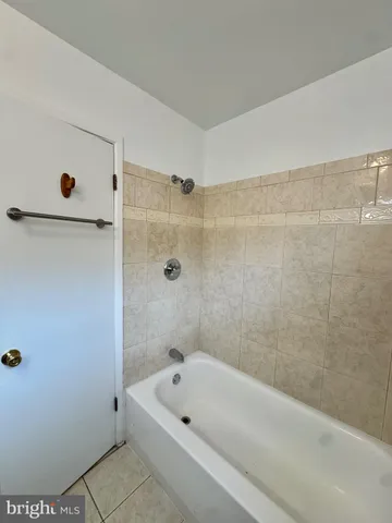 a bathroom with a tub a sink and a shower