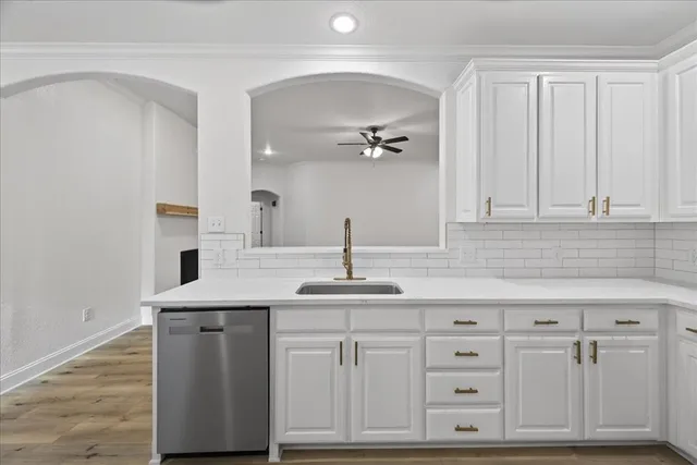 a kitchen with cabinets appliances and a sink