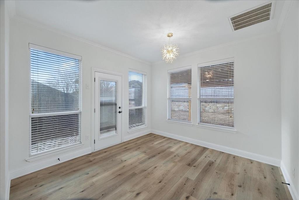 313 Nutmeg Court Burleson, TX 76028 - Photo 13 of 40 an empty room with wooden floor and windows