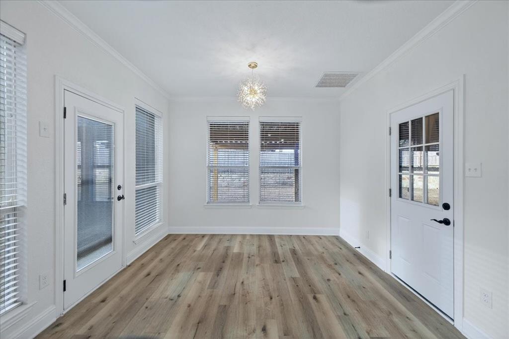 313 Nutmeg Court Burleson, TX 76028 - Photo 15 of 40 wooden floor in an empty room with a window