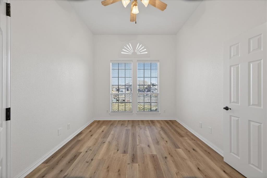 313 Nutmeg Court Burleson, TX 76028 - Photo 16 of 40 a view of an empty room with wooden floor and a window