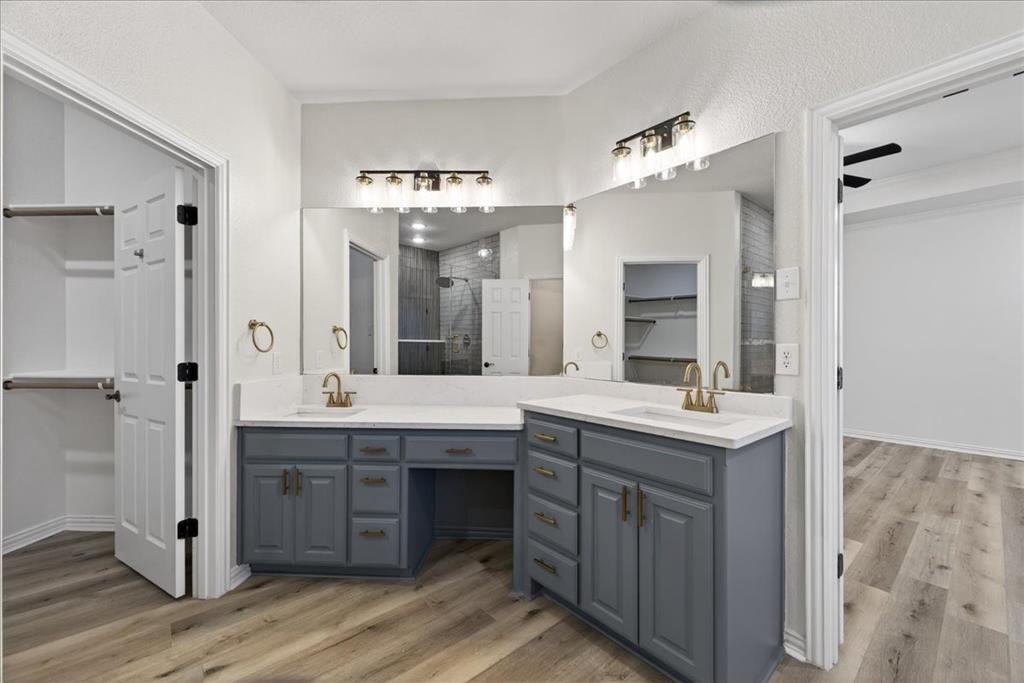313 Nutmeg Court Burleson, TX 76028 - Photo 23 of 40 a spacious bathroom with a granite countertop sink a mirror and shower