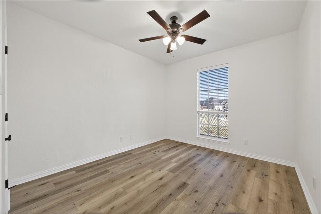 313 Nutmeg Court Burleson, TX 76028 - Photo 25 of 40 an empty room with wooden floor and windows