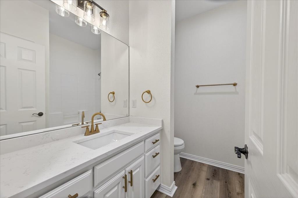 313 Nutmeg Court Burleson, TX 76028 - Photo 26 of 40 a bathroom with a sink a toilet and shower