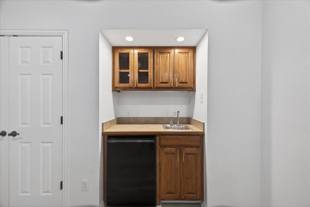 313 Nutmeg Court Burleson, TX 76028 - Photo 30 of 40 a kitchen with a sink and cabinets