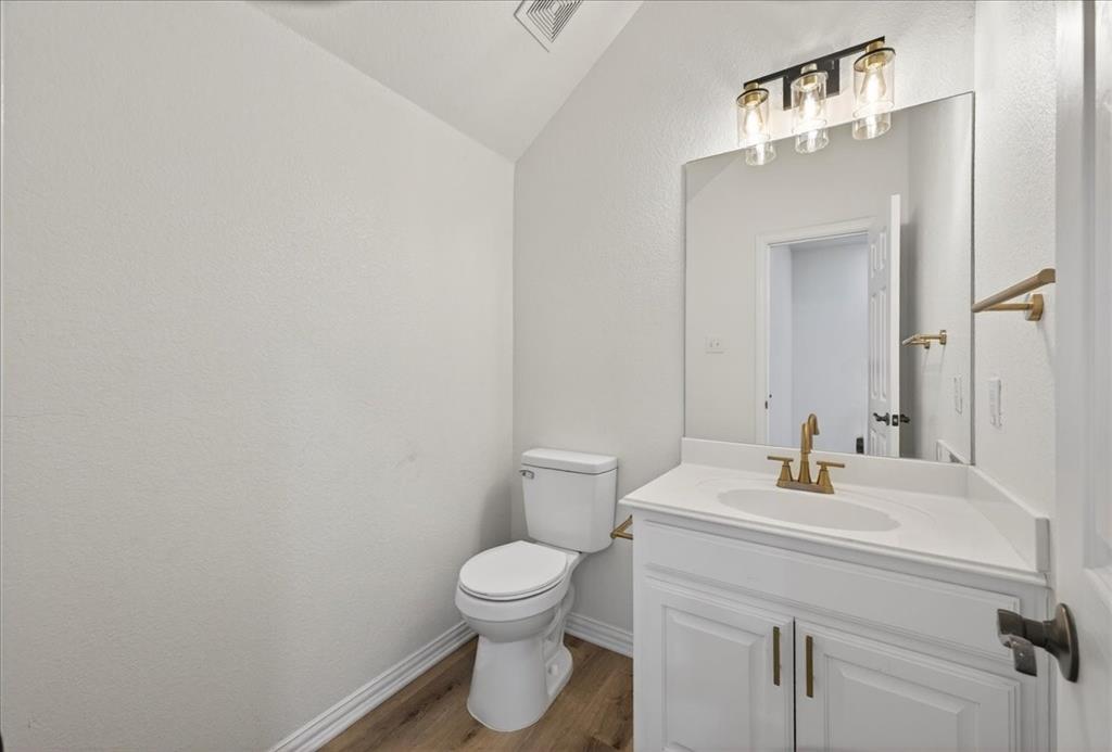 313 Nutmeg Court Burleson, TX 76028 - Photo 31 of 40 a bathroom with a sink toilet and vanity