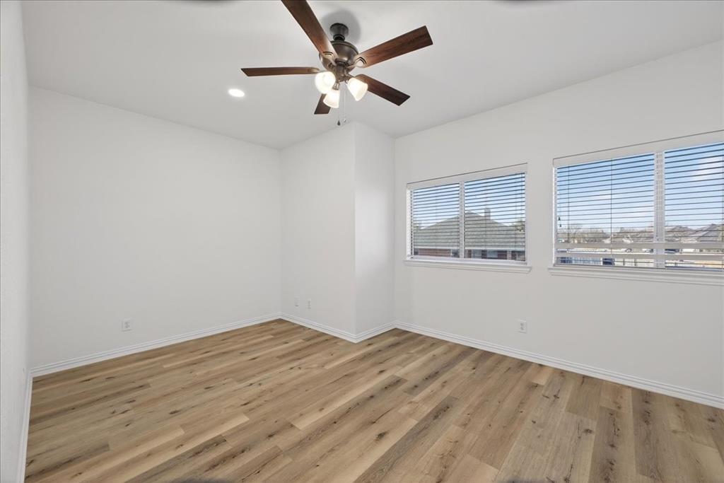 313 Nutmeg Court Burleson, TX 76028 - Photo 32 of 40 an empty room with wooden floor and windows