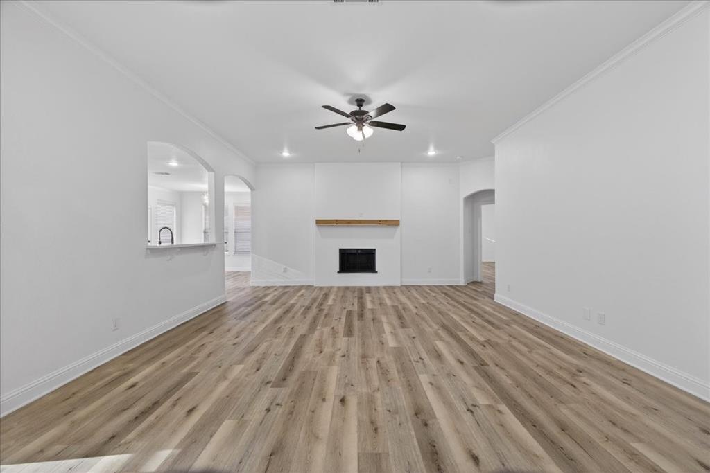 313 Nutmeg Court Burleson, TX 76028 - Photo 7 of 40 wooden floor in an empty room with a window