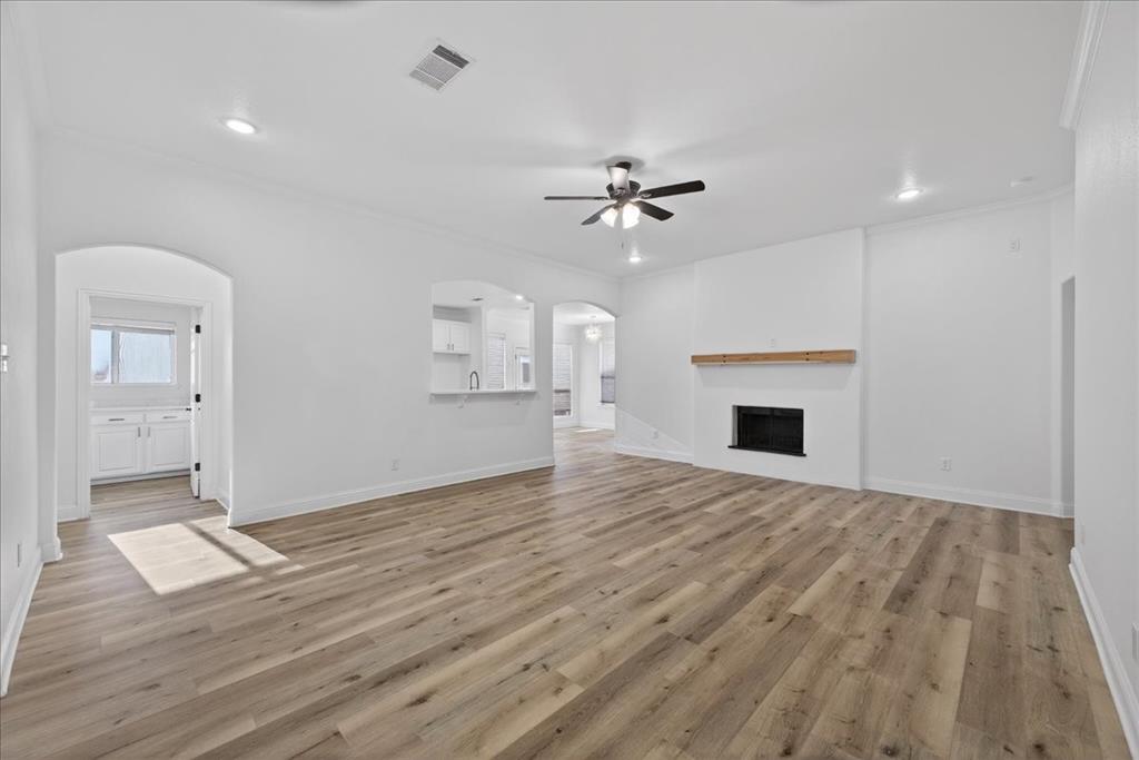 313 Nutmeg Court Burleson, TX 76028 - Photo 8 of 40 a view of empty room with wooden floor and fireplace