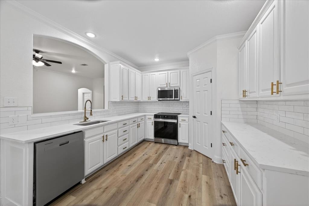 313 Nutmeg Court Burleson, TX 76028 - Photo 10 of 40 a large kitchen with cabinets