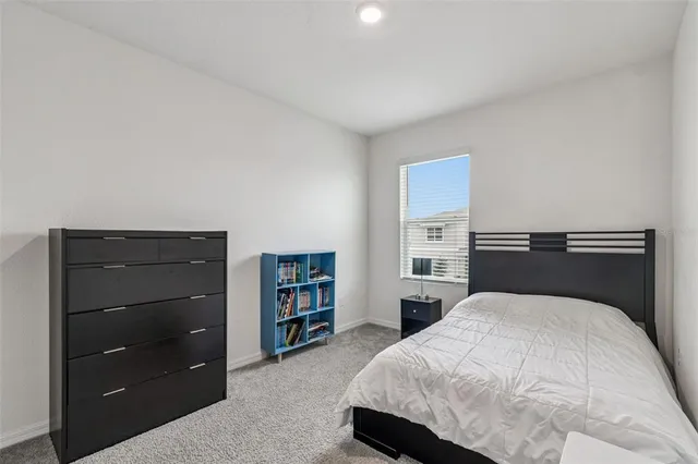 a living room with furniture a flat screen tv and a dining table
