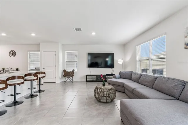 a living room with furniture a fireplace and a potted plant
