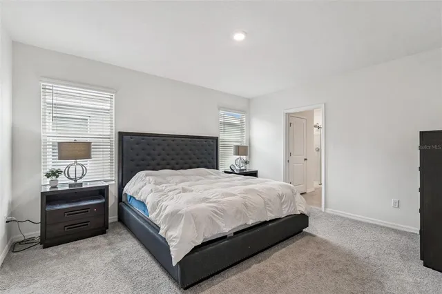 a living room with stainless steel appliances kitchen island granite countertop a sink and cabinets