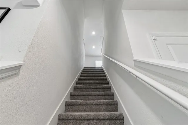 a white toilet sitting next to a shower