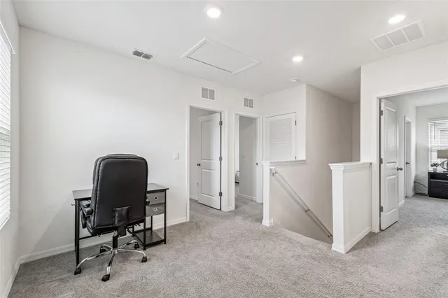 a view of a house with backyard and a tree