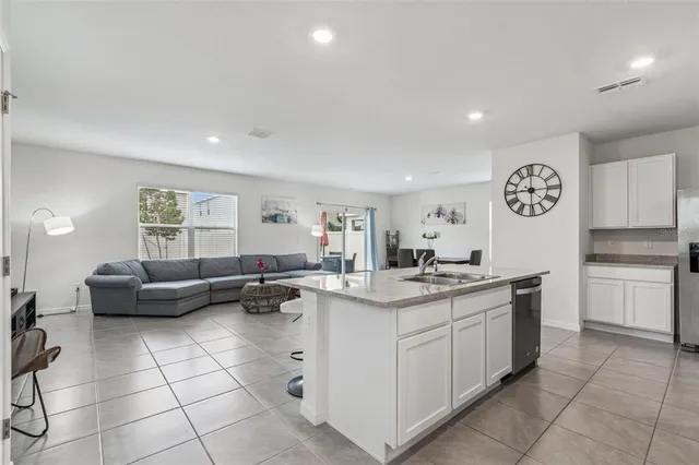 a kitchen with stainless steel appliances granite countertop a sink and a microwave