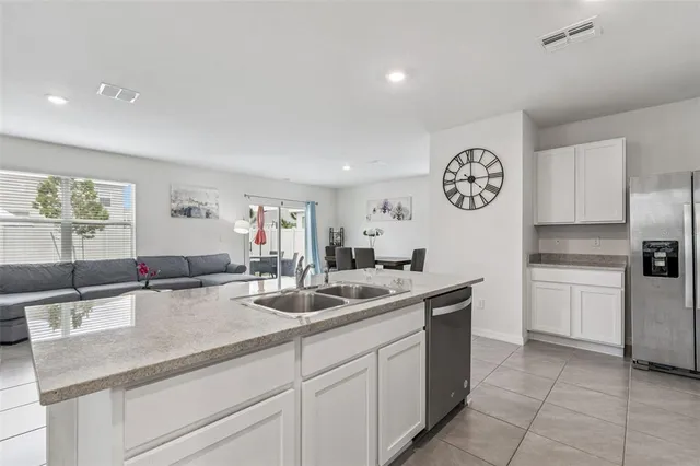 a kitchen with stainless steel appliances granite countertop a sink stove and microwave
