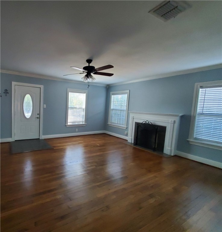 2806 Topeka Street Corpus Christi, TX 78404 - Photo 2 of 12 an empty room with wooden floor fireplace and windows