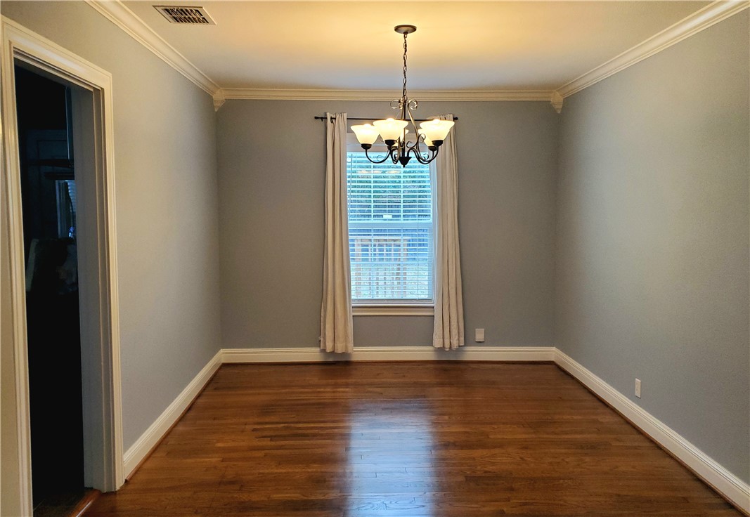2806 Topeka Street Corpus Christi, TX 78404 - Photo 4 of 12 a view of a room with wooden floor chandelier and windows