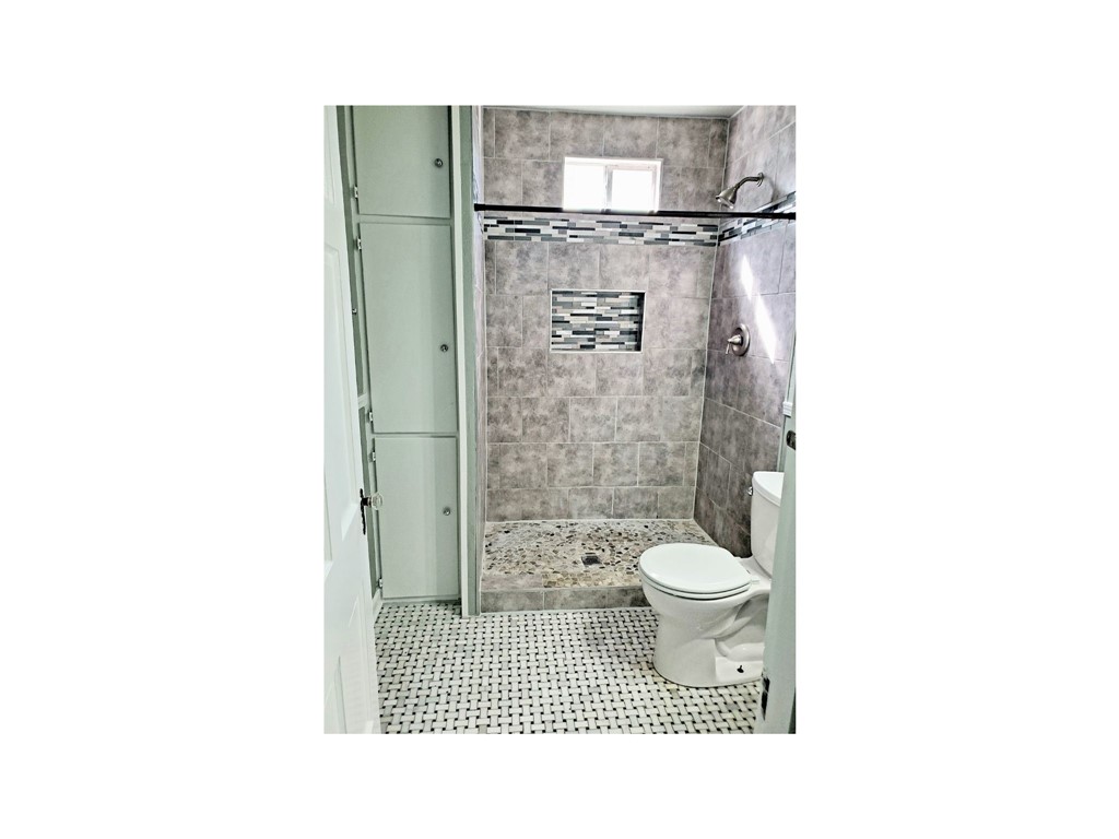2806 Topeka Street Corpus Christi, TX 78404 - Photo 5 of 12 a bathroom with a toilet and a shower