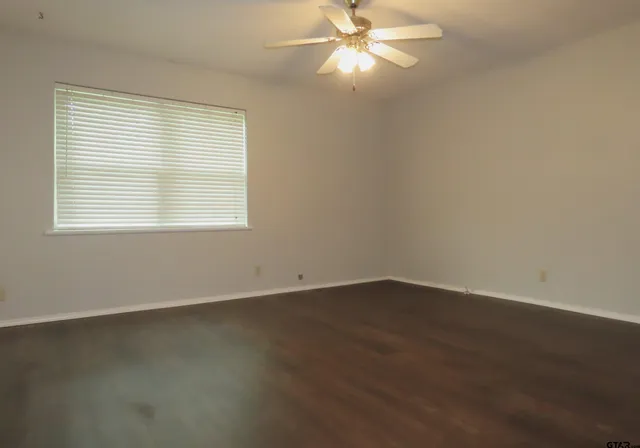 an empty room with windows and closet