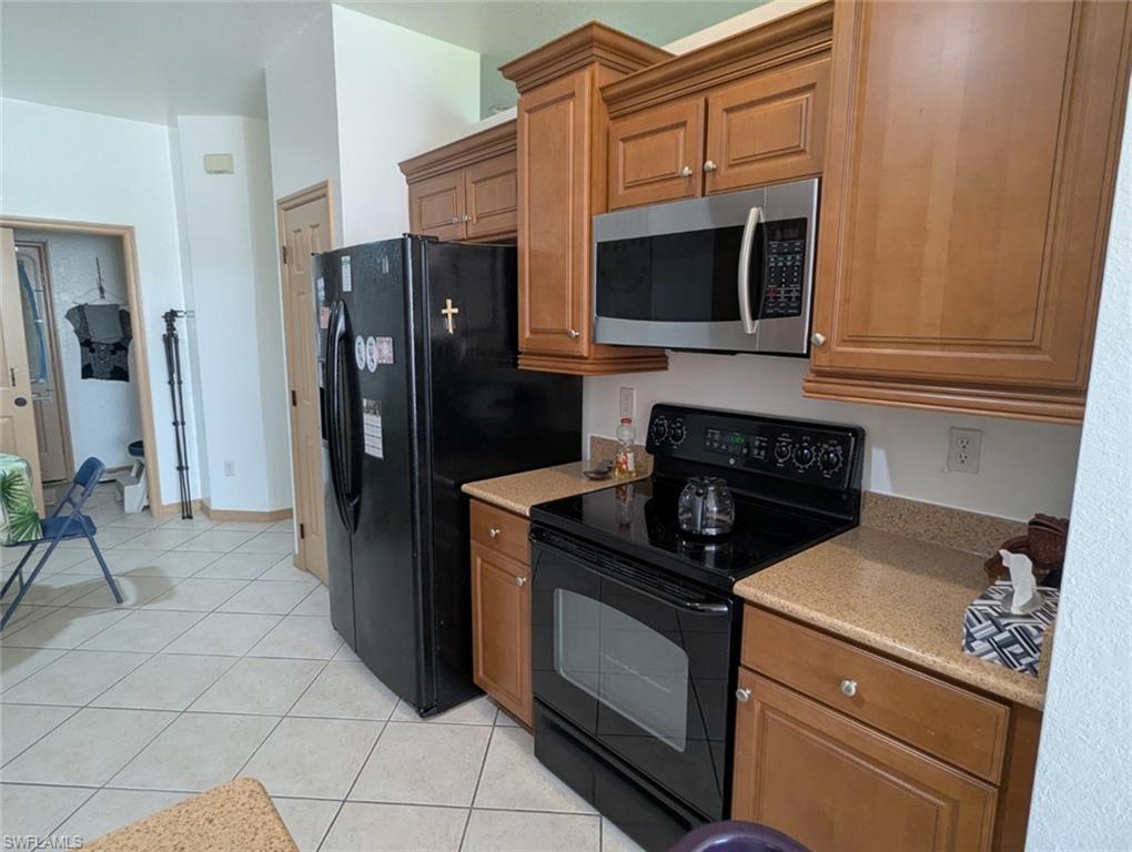 20176 Larino Loop Estero, FL 33928 - Photo 11 of 31 a kitchen with granite countertop a stove and a microwave