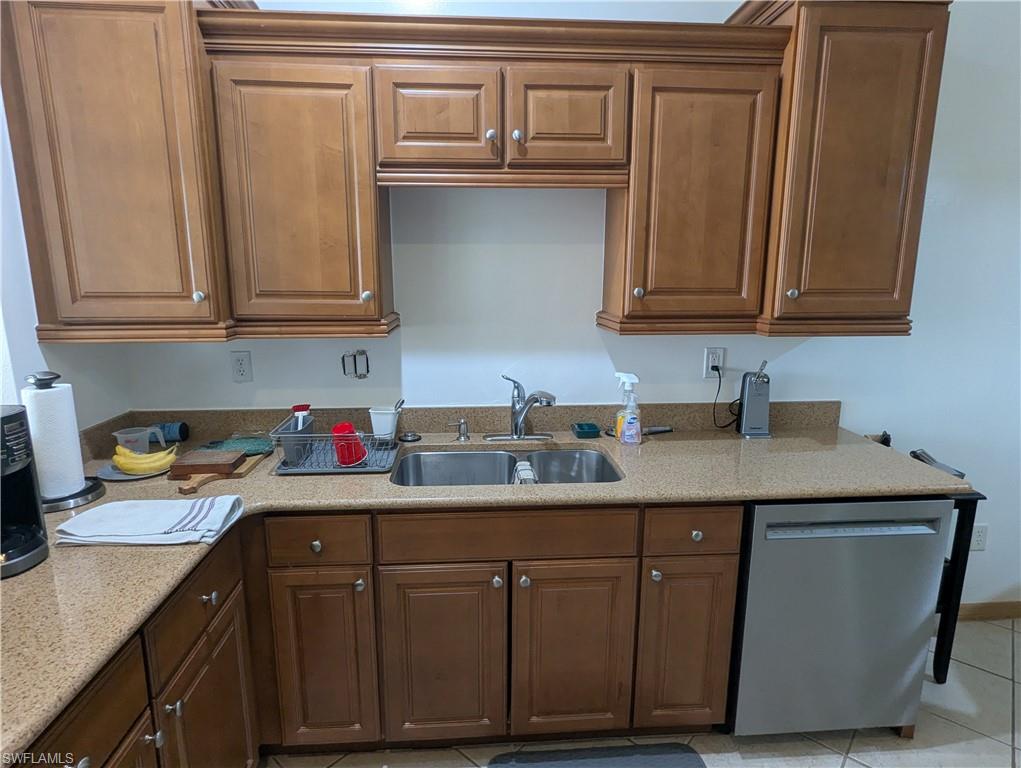 20176 Larino Loop Estero, FL 33928 - Photo 12 of 31 a kitchen with stainless steel appliances granite countertop a sink and cabinets