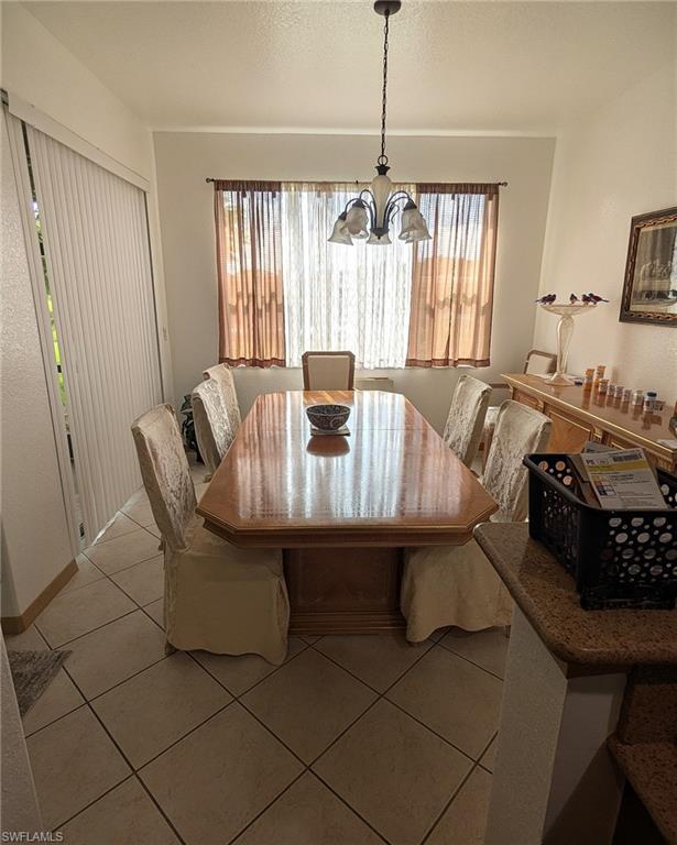 20176 Larino Loop Estero, FL 33928 - Photo 13 of 31 a view of a dining room with furniture window and chandelier
