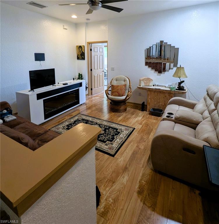 20176 Larino Loop Estero, FL 33928 - Photo 15 of 31 a living room with furniture and a flat screen tv