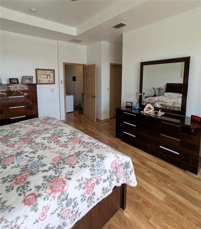 20176 Larino Loop Estero, FL 33928 - Photo 20 of 31 a bedroom with a bed and a large mirror on dresser