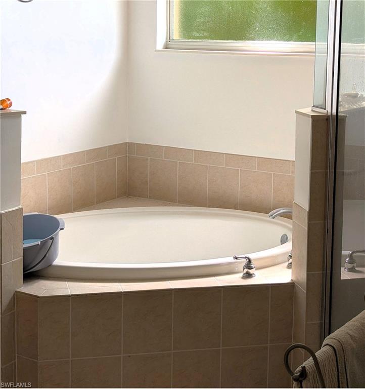 20176 Larino Loop Estero, FL 33928 - Photo 22 of 31 a bathroom with a bathtub and a window