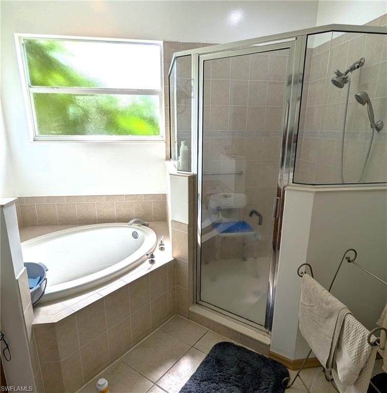 20176 Larino Loop Estero, FL 33928 - Photo 23 of 31 a bathroom with a tub and shower