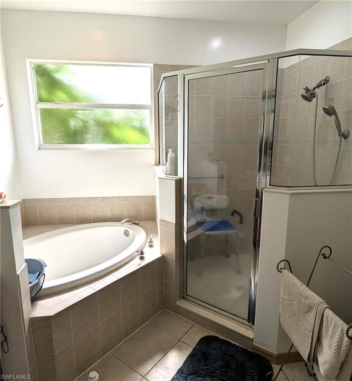 20176 Larino Loop Estero, FL 33928 - Photo 24 of 31 a bathroom with a tub a sink and a shower