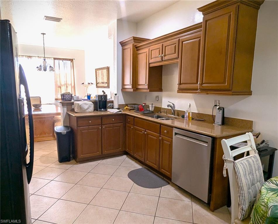 20176 Larino Loop Estero, FL 33928 - Photo 9 of 31 a kitchen with a sink stove and cabinets
