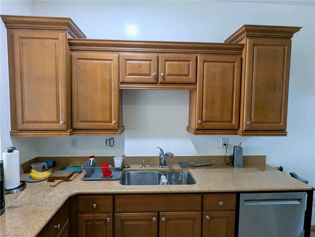 20176 Larino Loop Estero, FL 33928 - Photo 10 of 31 a kitchen with stainless steel appliances granite countertop a sink dishwasher stove and cabinets