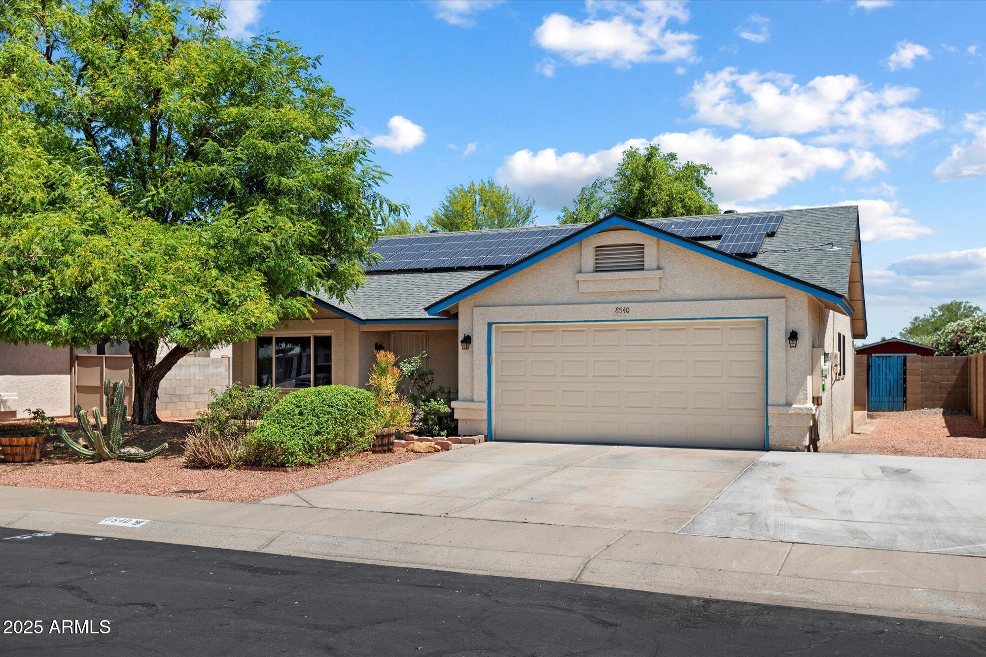 8540 West Ocotillo Road Glendale, AZ 85305 - Photo 2 of 22 a front view of a house with a yard and garage