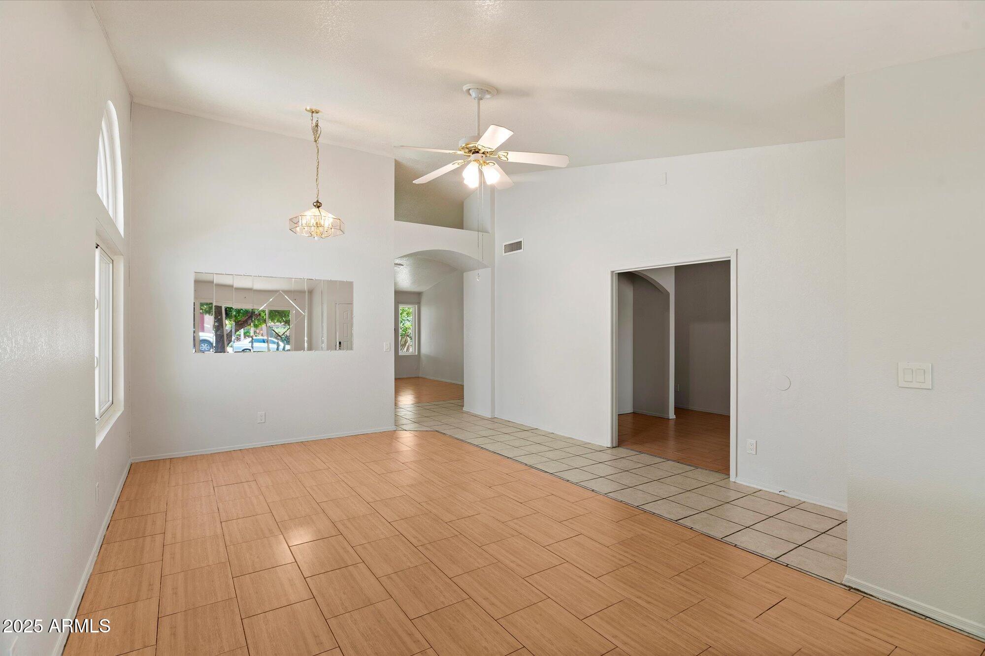 8540 West Ocotillo Road Glendale, AZ 85305 - Photo 4 of 22 a view of an empty room with window and chandelier fan