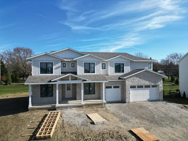 a front view of a house with a garden and yard