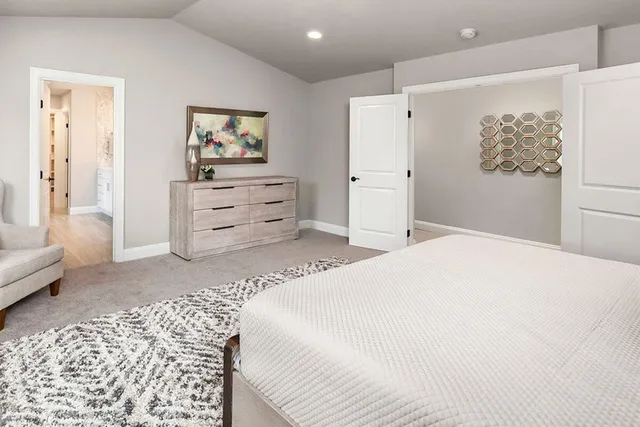 a bedroom with a bed and a couch