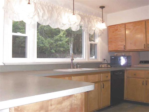 98 Southbridge Road Charlton, MA 01507 - Photo 9 of 30 a bathroom with a sink and a large window