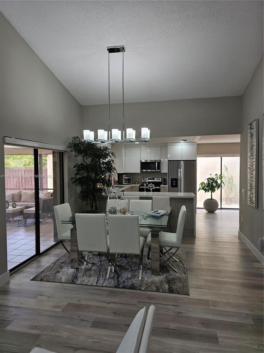 4323 Southwest 148th Place Miami, FL 33185 - Photo 14 of 70 a view of a dining room with furniture window and wooden floor