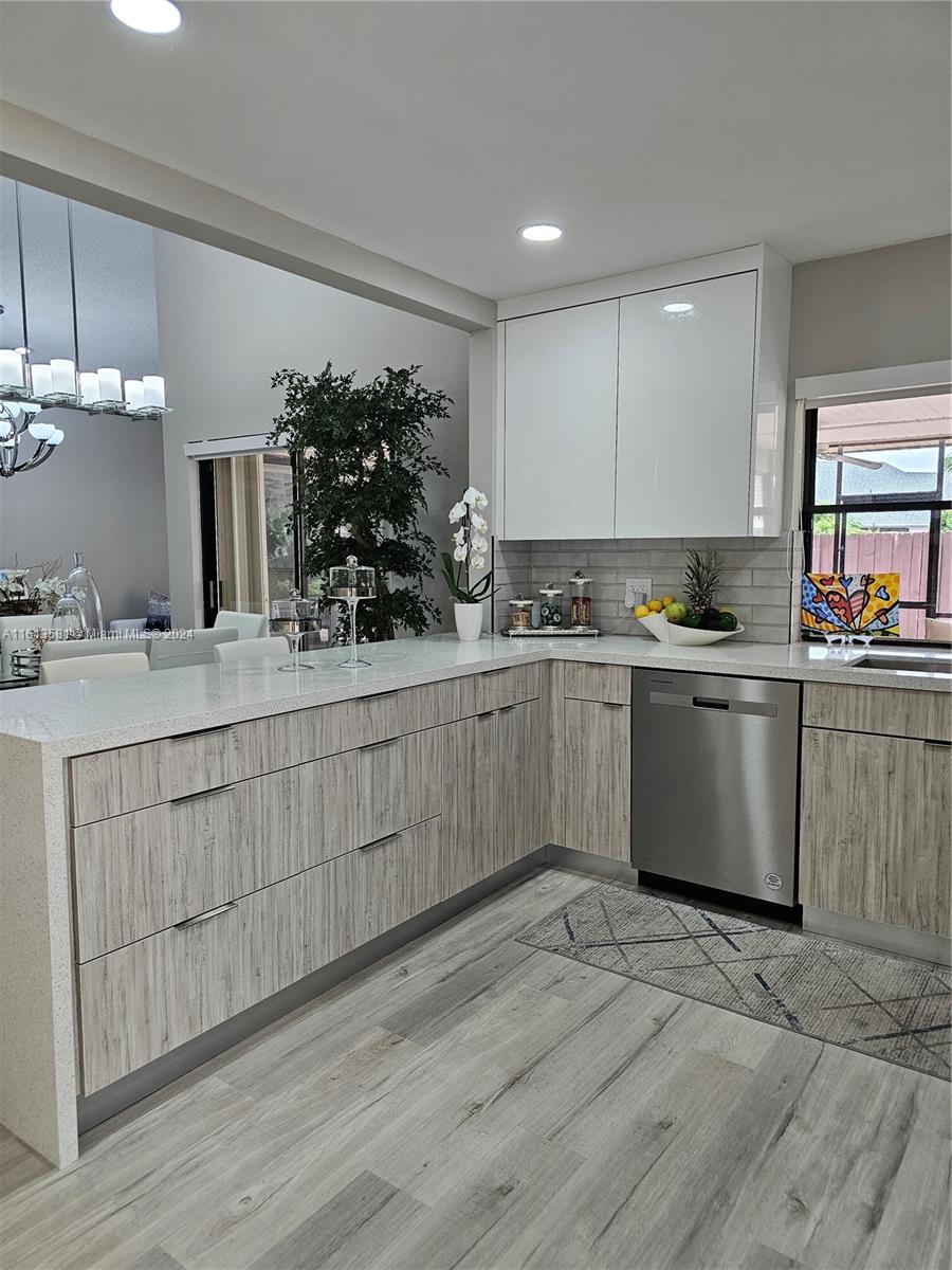 4323 Southwest 148th Place Miami, FL 33185 - Photo 18 of 70 a kitchen with a sink cabinets and wooden floor