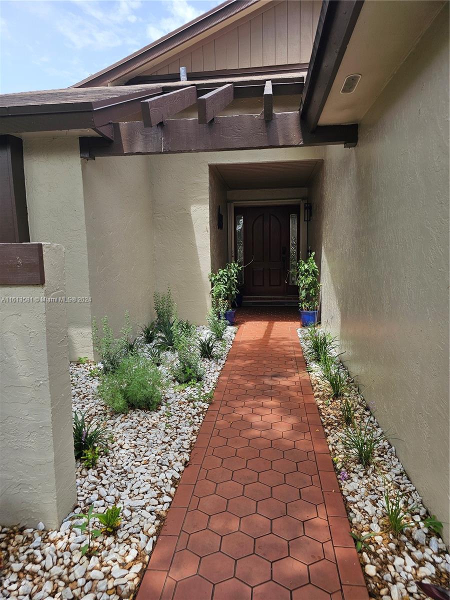 4323 Southwest 148th Place Miami, FL 33185 - Photo 2 of 70 a view of a pathway along the house