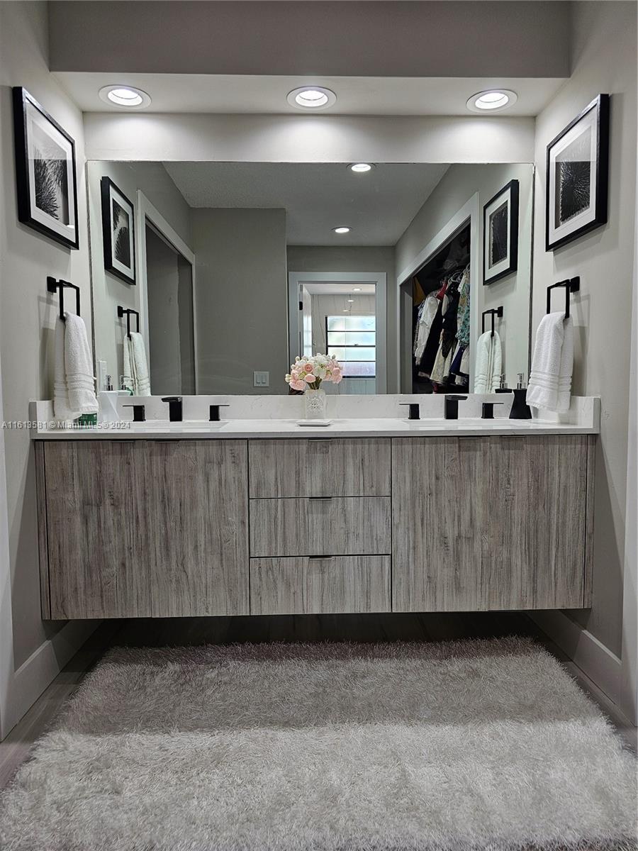 4323 Southwest 148th Place Miami, FL 33185 - Photo 33 of 70 a bathroom with a sink and a mirror