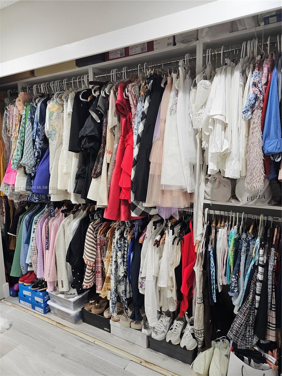 4323 Southwest 148th Place Miami, FL 33185 - Photo 34 of 70 a view of walk in closet with clothes