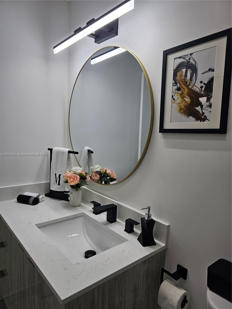 4323 Southwest 148th Place Miami, FL 33185 - Photo 40 of 70 a bathroom with a sink and a mirror