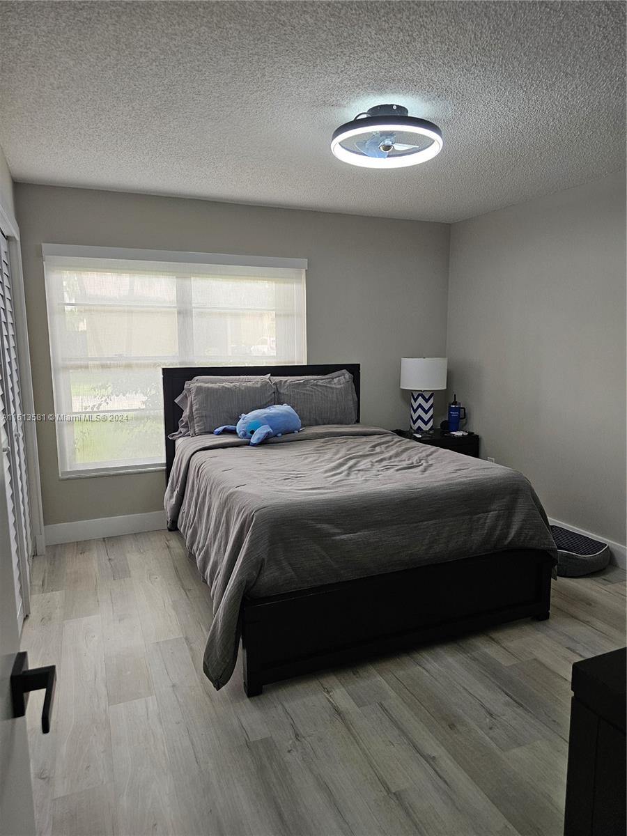 4323 Southwest 148th Place Miami, FL 33185 - Photo 41 of 70 a bedroom with a bed and a window