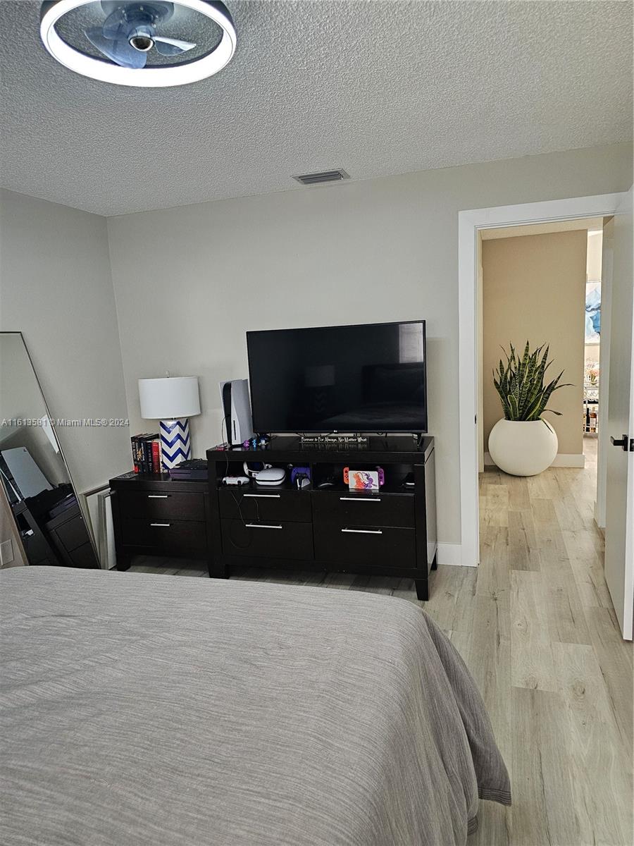 4323 Southwest 148th Place Miami, FL 33185 - Photo 42 of 70 a bedroom with a bed and a television