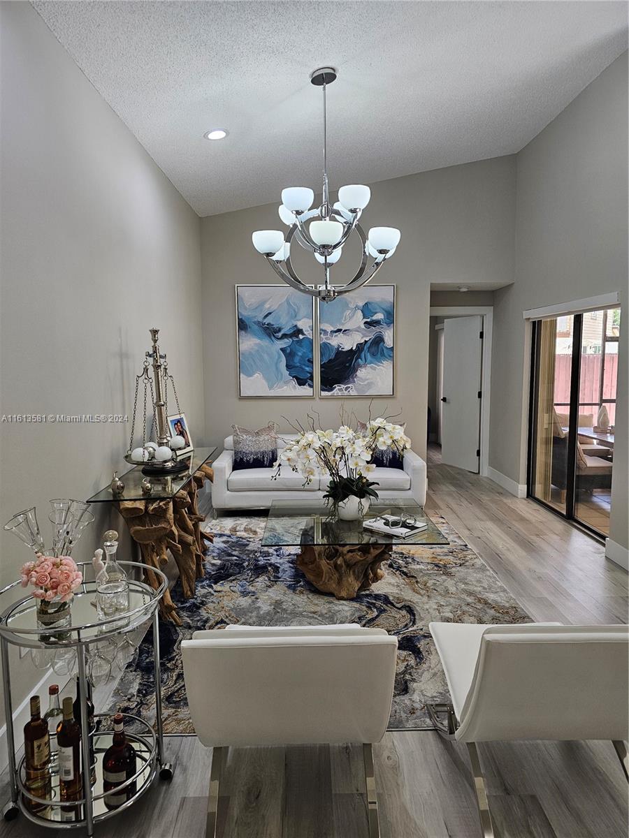 4323 Southwest 148th Place Miami, FL 33185 - Photo 5 of 70 a very nice looking dining room with a table or chandelier and a couch